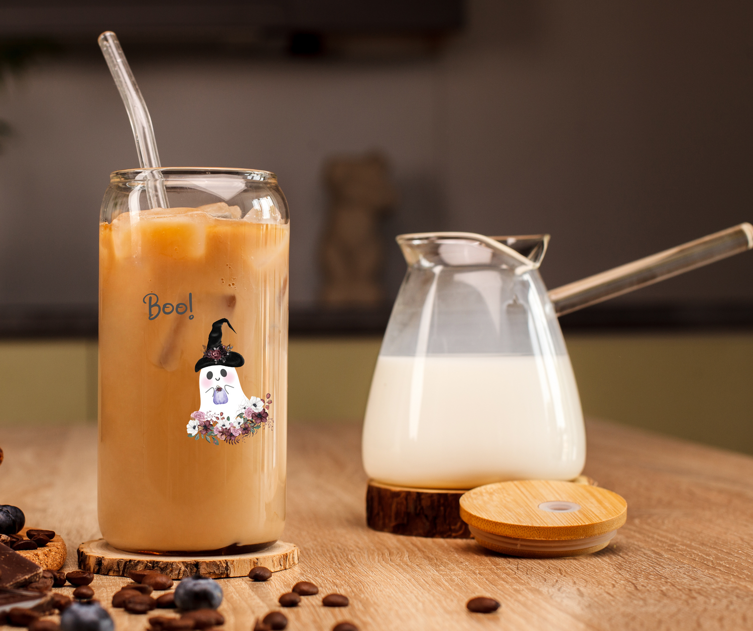 Boo Ghost beer can tumbler with straw and lid. A glass of milk in the background and the tumbler is filled with iced coffee.